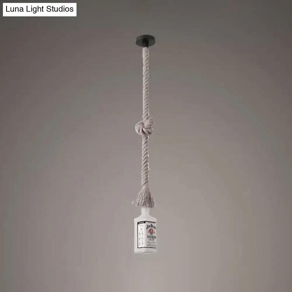 A frosted white glass island lamp shaped like a black wine bottle pendant light hanging from a beige knotted rope