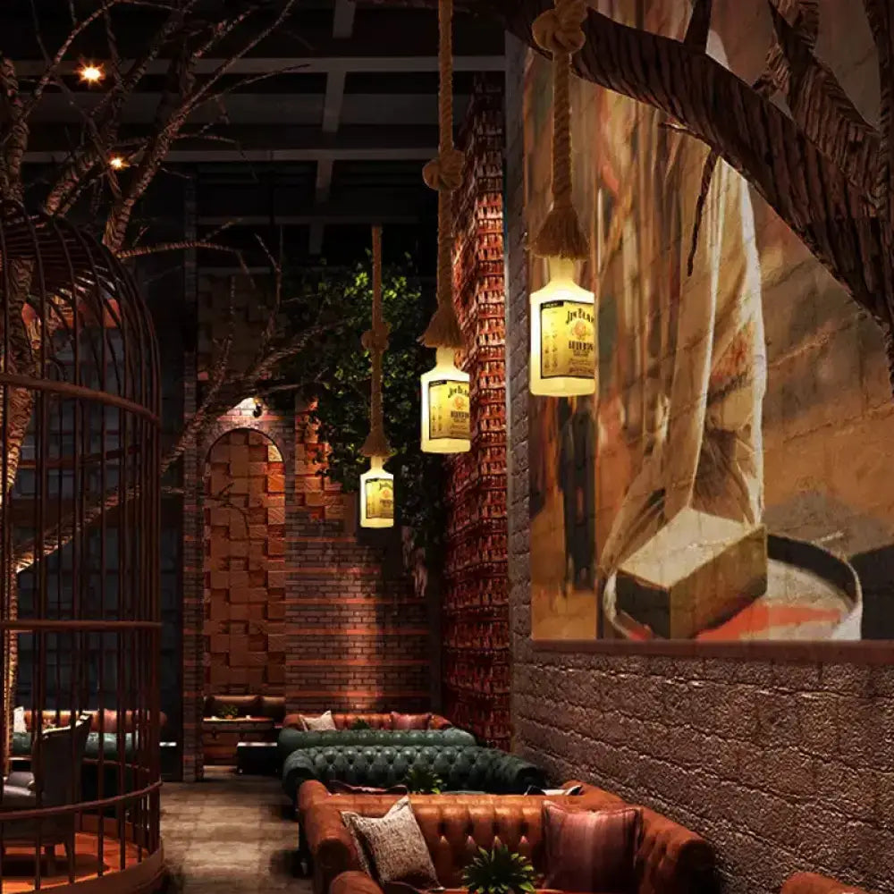 Warmly glowing jack daniel’s whiskey bottle pendant lights hang from thick rope cords in black wine design lamp