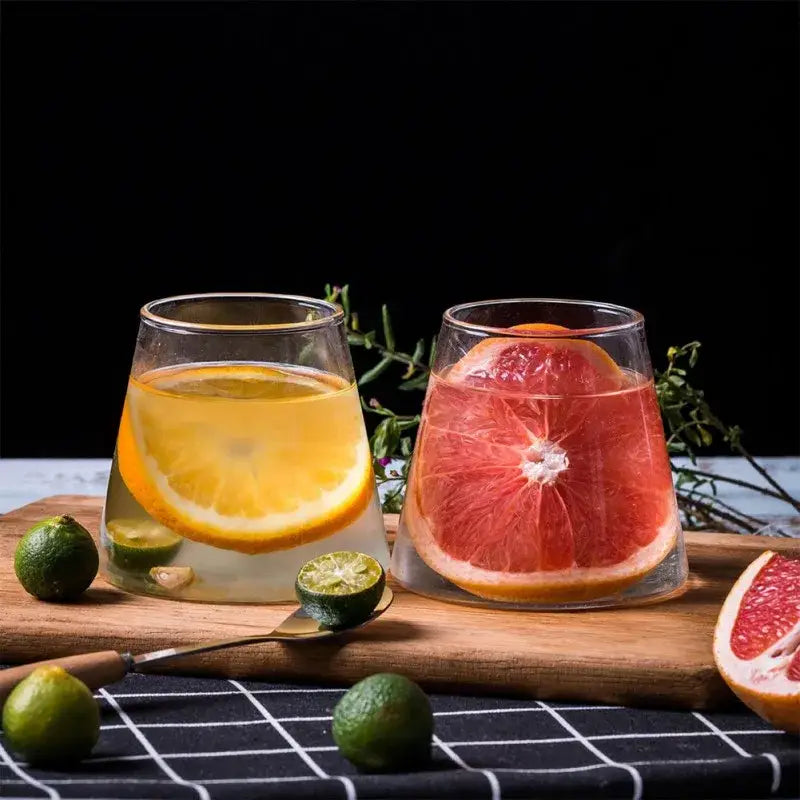 Two clear glass tumblers in the decorbites fuji mountain glass drinkware set filled with citrus and grapefruit drinks