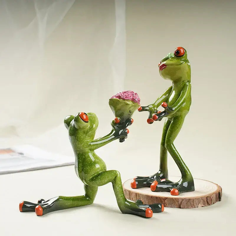 Green resin frog couple figurine with red eyes and orange toes presenting pink rose bouquet decorbites funny frog