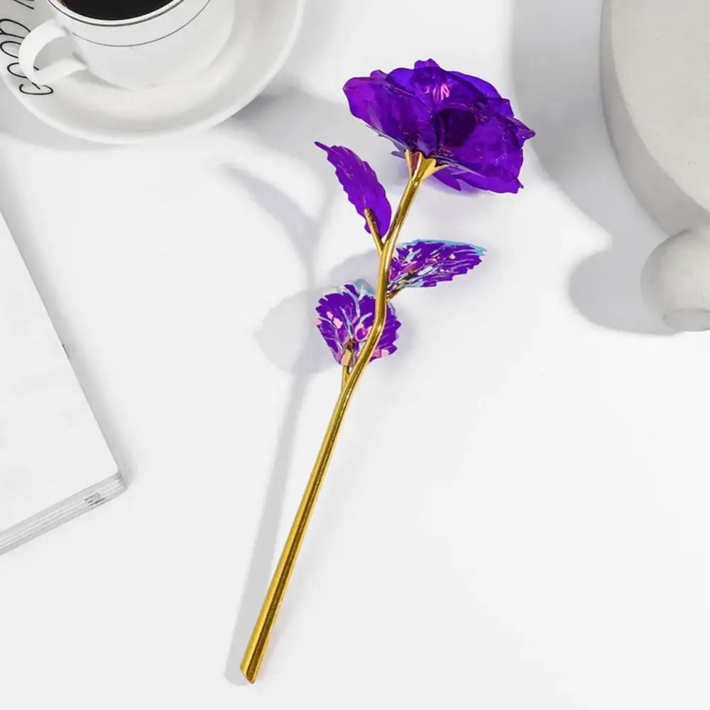 A vibrant purple glass galaxy rose with a golden stem and leaves from decorbites galaxy wedding centerpiece