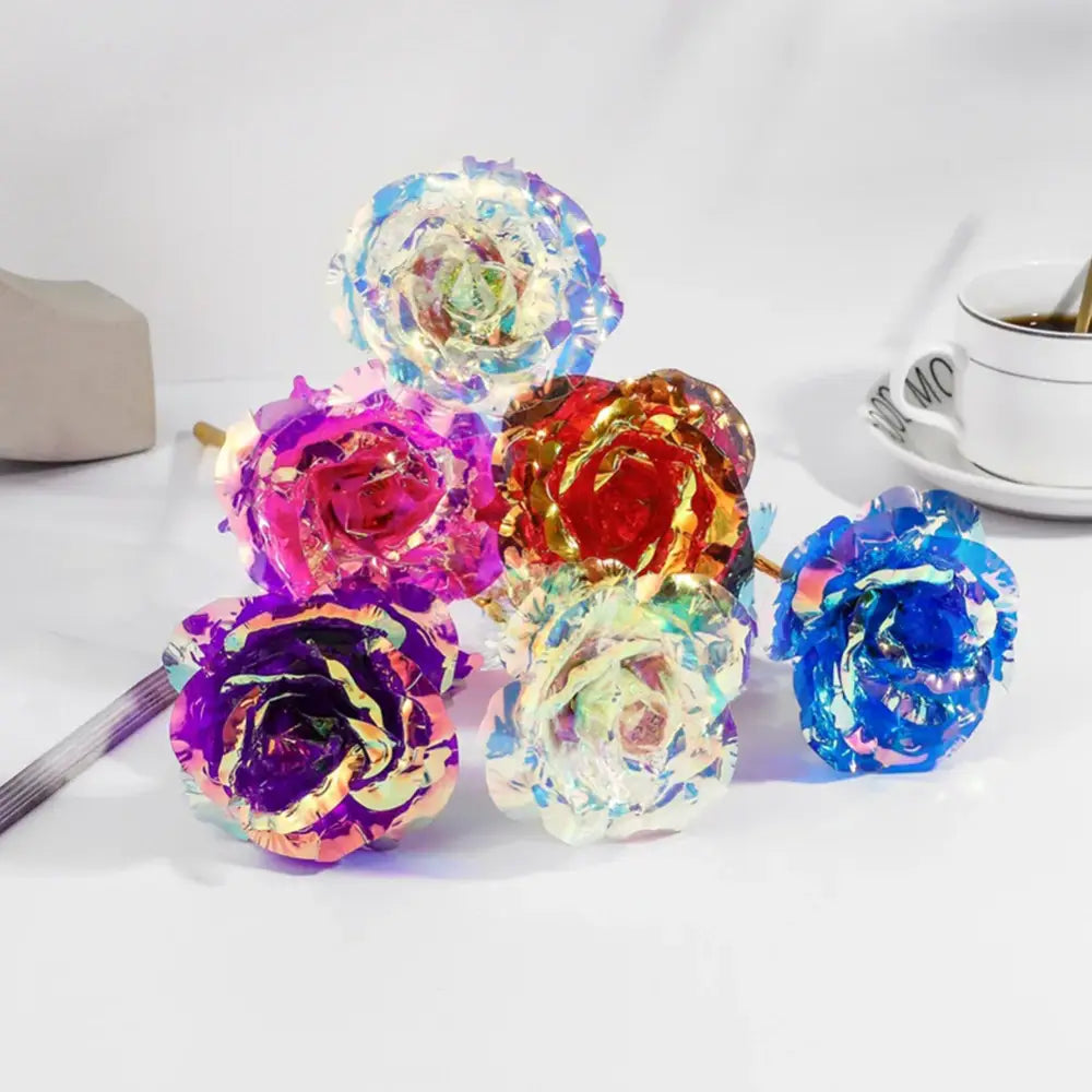 A decorbites galaxy rose centerpiece featuring iridescent metallic roses in blue purple red and gold hues for weddings