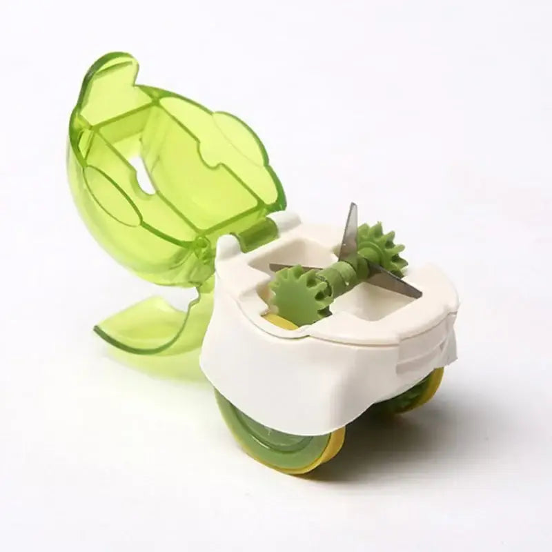A lime green and white plastic decorbites garlic chopper with leaf-shaped lid and rotating blades for mincing garlic