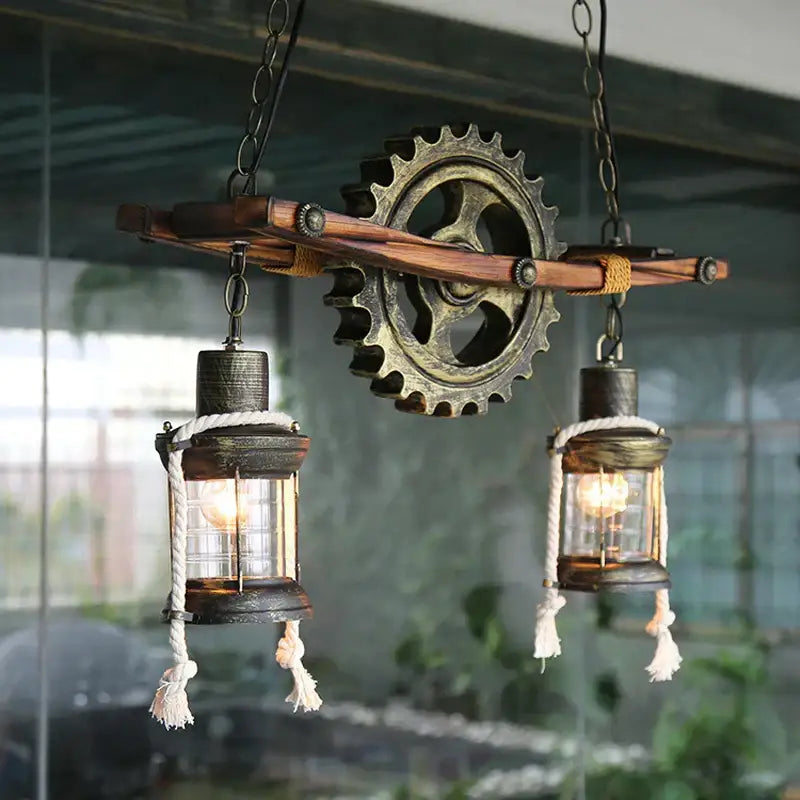 Decorbites gear industrial chandelier pendant with two glass lanterns and rope tassels hanging from wooden beam