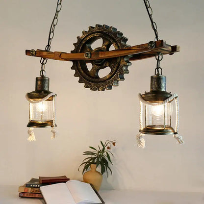 Decorbites gear industrial chandelier pendant with two glass lanterns and rope detail suspended from wooden beam