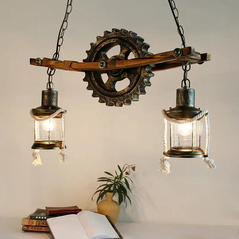 Decorbites gear industrial chandelier pendant with two glass lanterns and rope detail suspended from wooden beam
