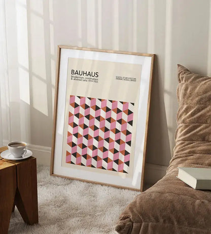 A framed geometric bauhaus canvas art with pink black and beige tones for mid century decor by decorbites