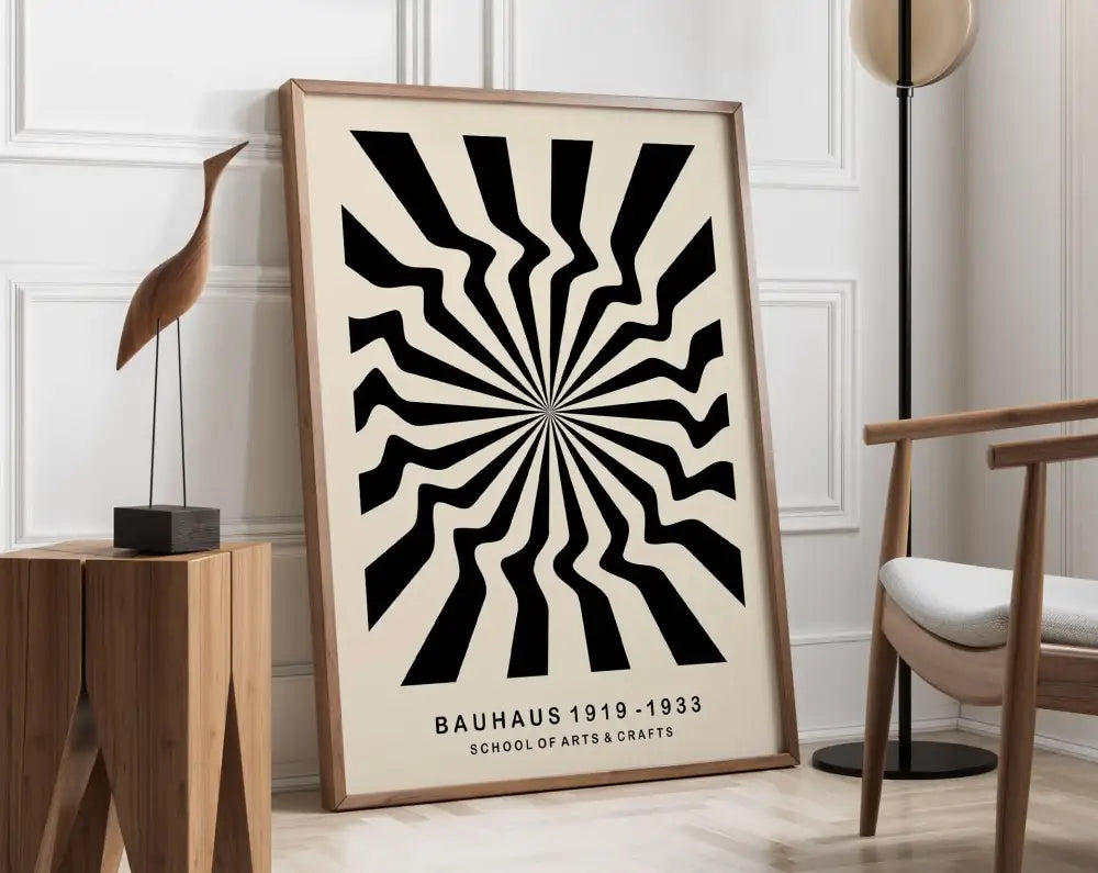 A framed decorbites™ geometric bauhaus canvas poster with bold black and cream radial stripes in a light wood frame
