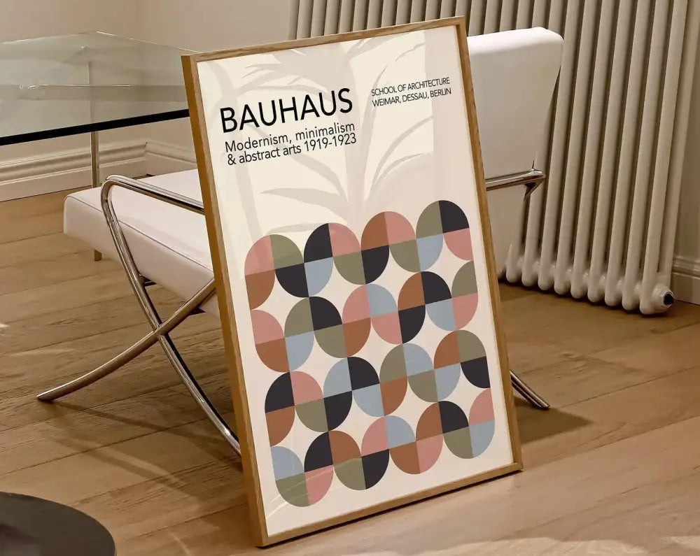 A framed decorbites geometric bauhaus canvas poster with overlapping circles in pastel and earthy tones in a light wood frame