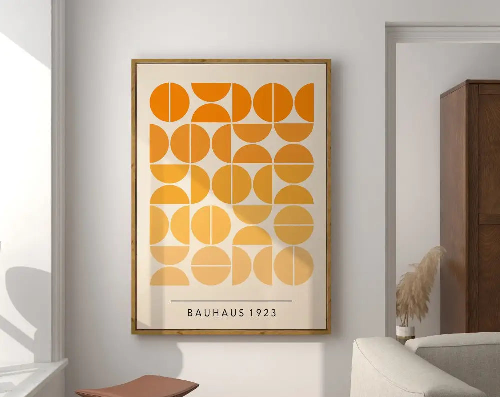 A framed geometric bauhaus canvas poster with orange and yellow circles and bauhaus 1923 text on off-white background