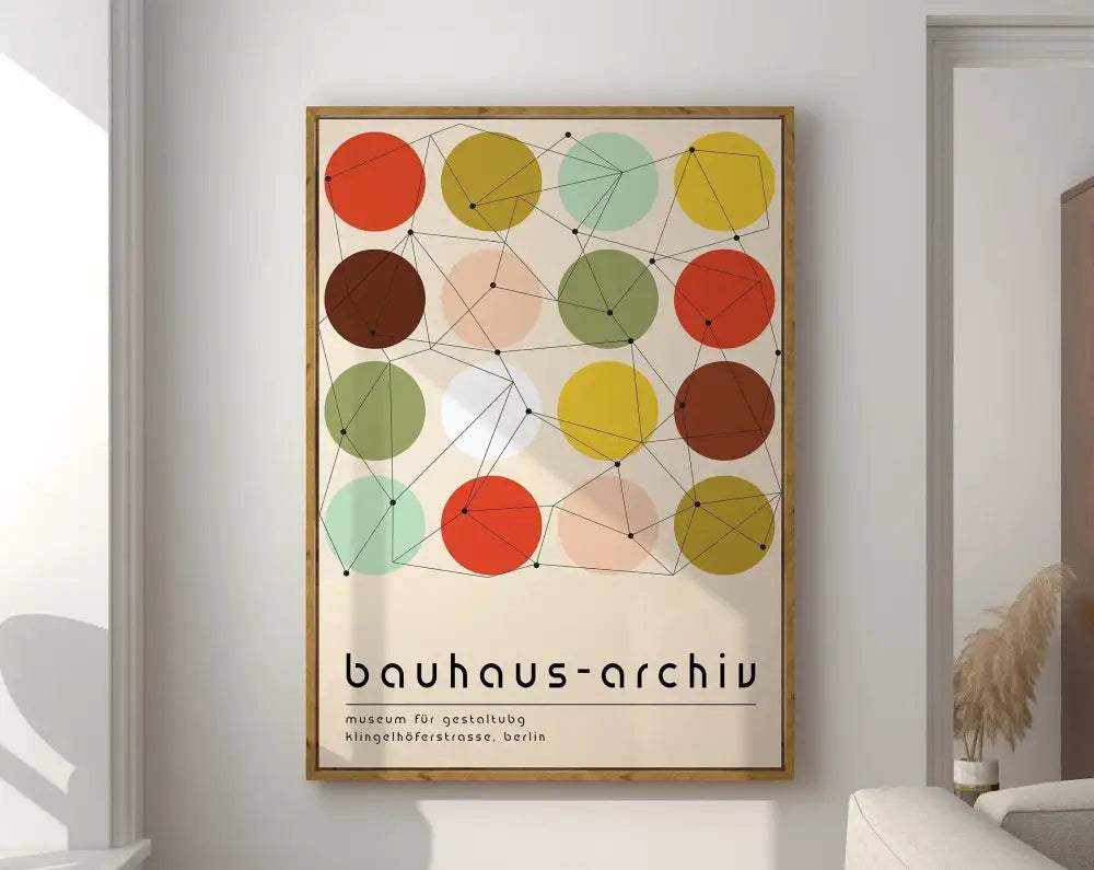A framed decorbites bauhaus canvas poster with geometric overlapping circles in orange yellow green and brown on cream