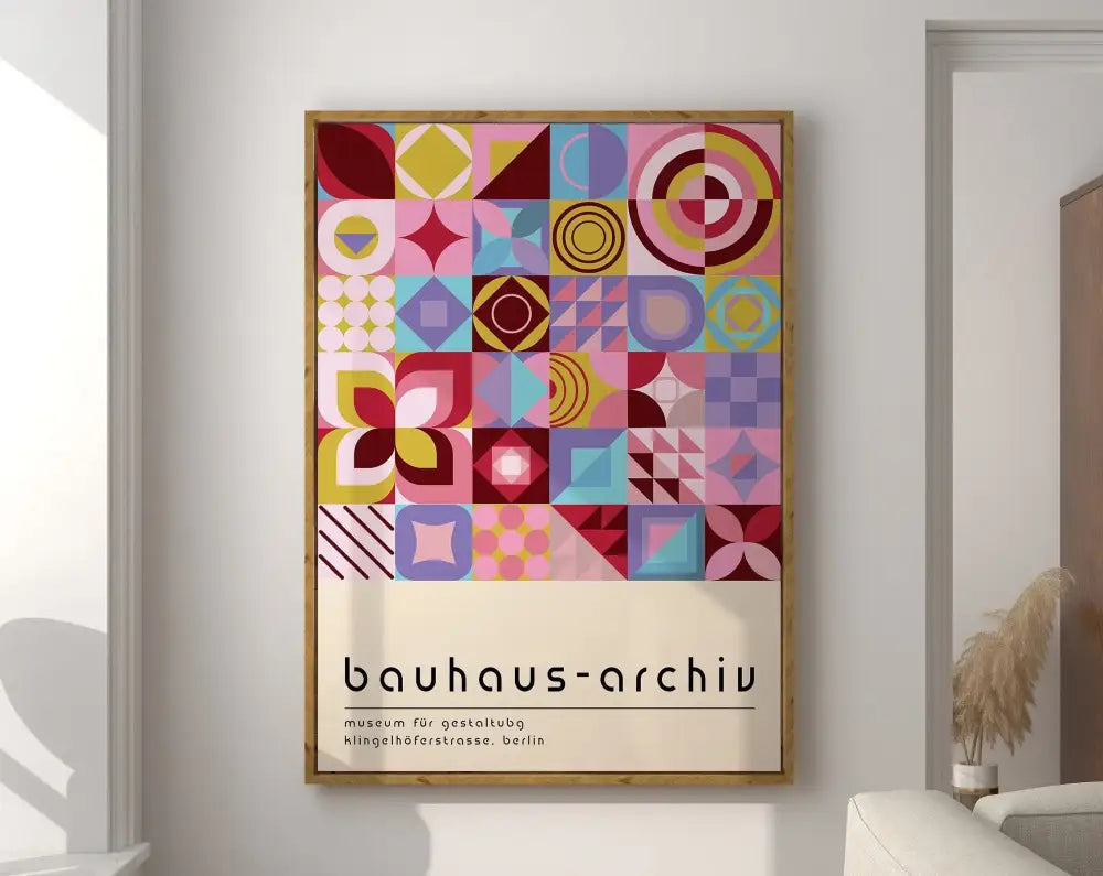 A framed bauhaus canvas poster featuring a vibrant geometric bauhaus design in pink yellow blue and purple on cream