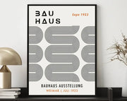 Black-framed geometric bauhaus canvas poster with bold text and orange expo 1923 detail on cream background by decorbites