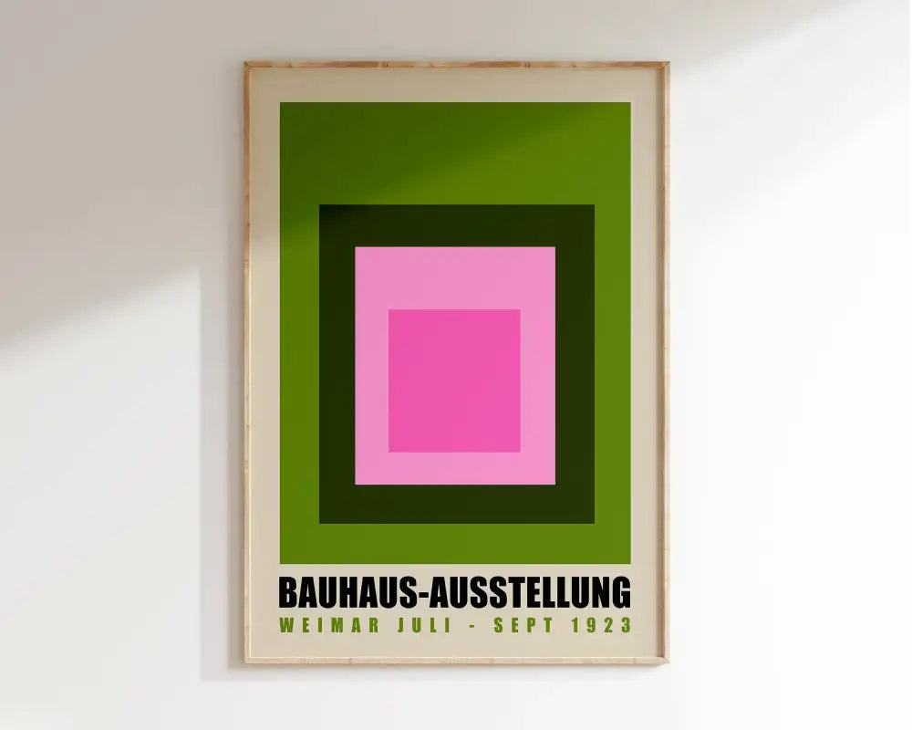 A framed decorbites™ geometric bauhaus canvas poster with vibrant pink and green concentric squares and black text