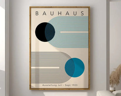 A framed decorbites geometric bauhaus canvas print with bold black and teal shapes on cream in light wood frame