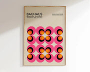 A framed decorbites™ geometric bauhaus canvas print featuring vibrant pink circles with orange black rings wall art