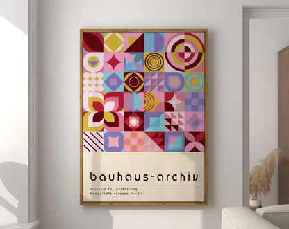 A framed DecorBites™ geometric bauhaus canvas wall art with vibrant pink, yellow, blue, and purple abstract shapes on cream