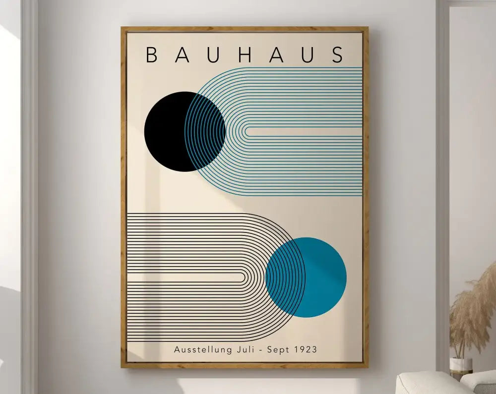 A framed decorbites™ geometric bauhaus canvas wall art with bold black and teal shapes on cream in a light wood frame