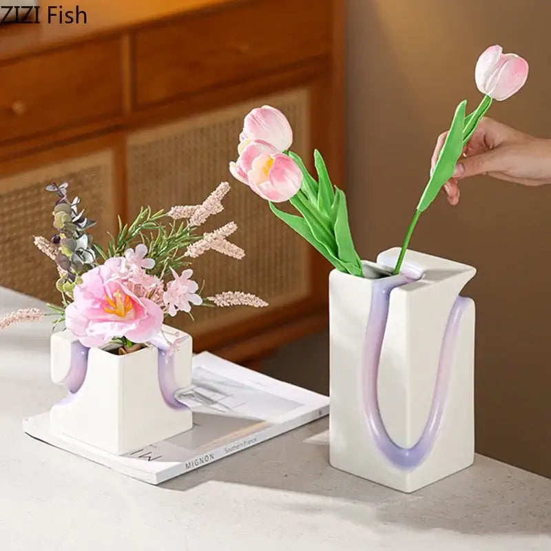 White ceramic decorbites geometric blocks vase with purple handle design holding pink tulips for living room decor