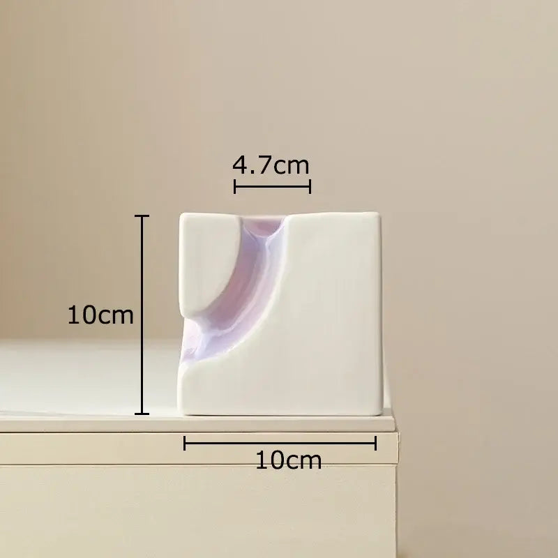 Minimalist white ceramic Decorbites geometric blocks vase with curved indentation and lavender interior for living room decor