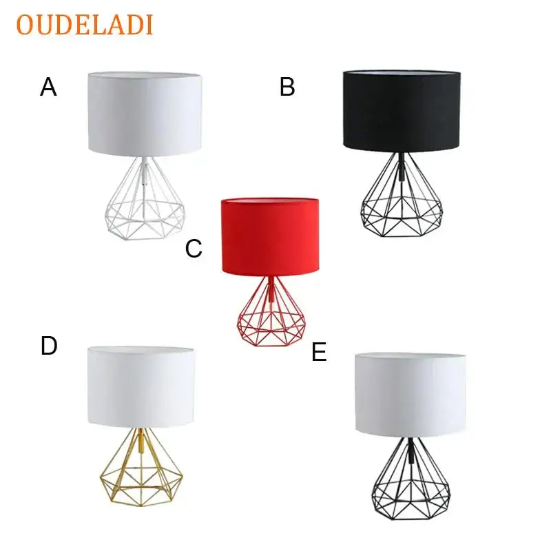 Decorbites geometric gold desk lamp featuring black, white, and red cylindrical shades with wireframe bases for bedroom use