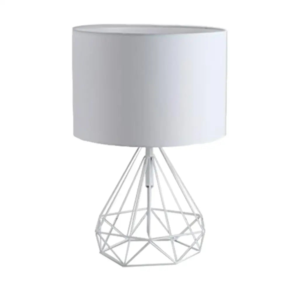 White geometric gold desk lamp with wire base and cylindrical fabric shade for black bedroom table light by decorbites geometric gold