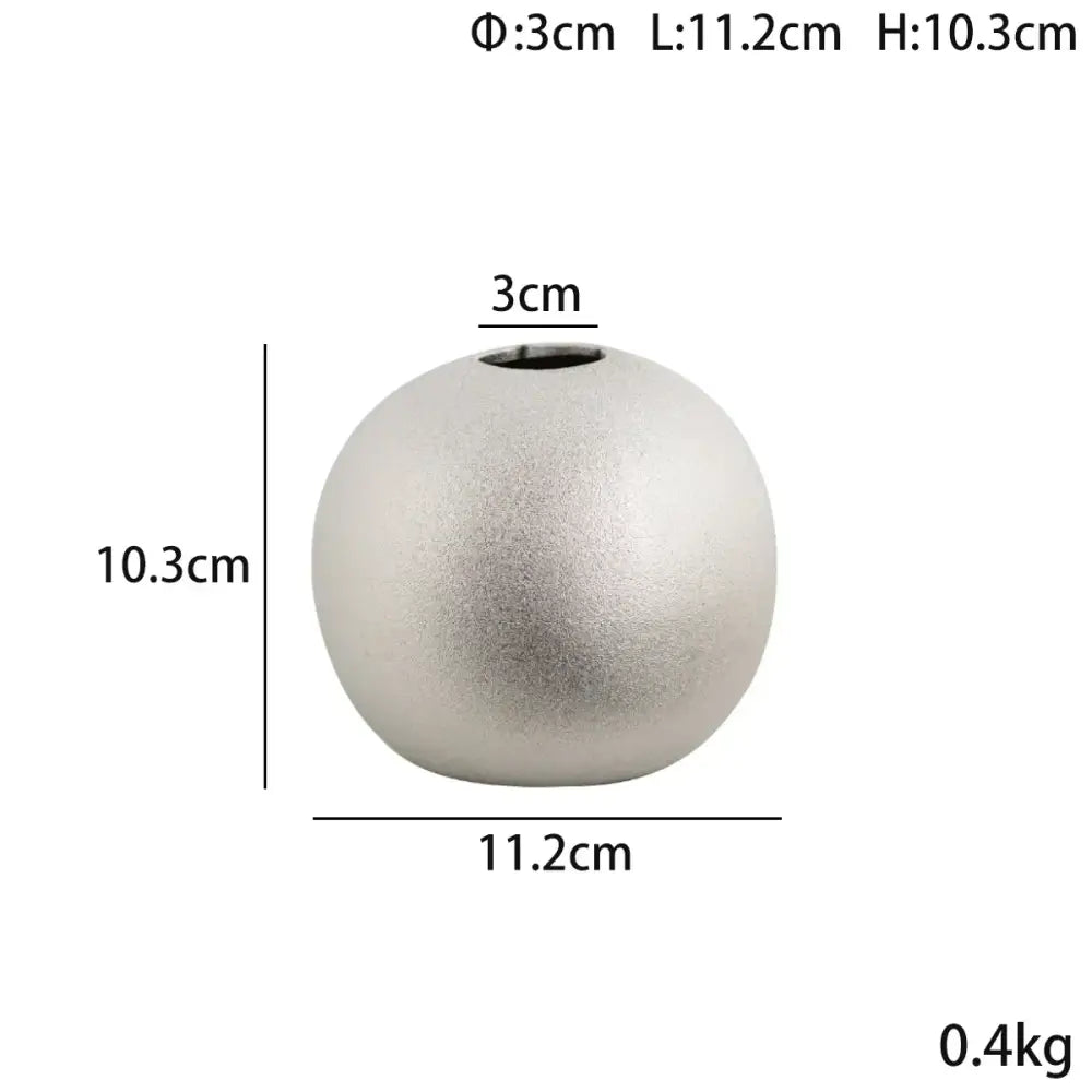 A sleek matte silver spherical ceramic vase with subtle texture and small opening from decorbites geometric gold collection