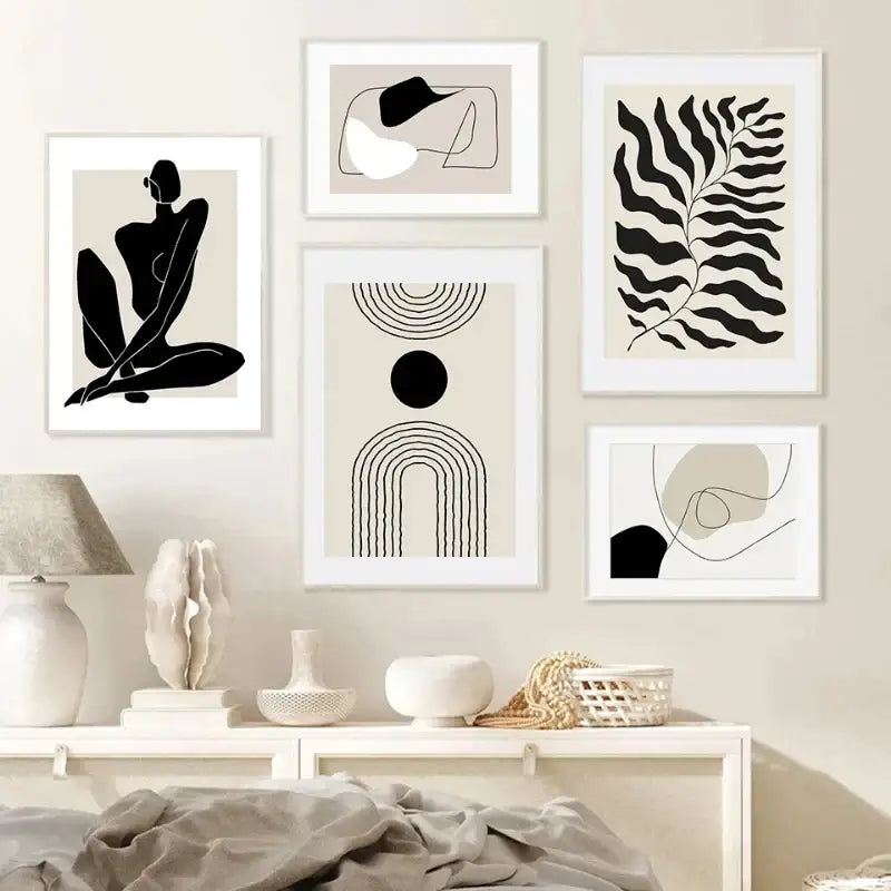 Set of five minimalist black and beige boho canvas prints with geometric leaf rainbow designs in white frames