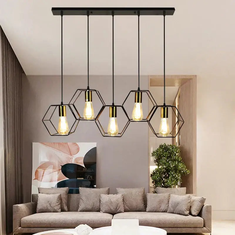 Black hexagonal metal pendant light with brass accents and exposed bulbs in the decorbites geometric led chandelier design