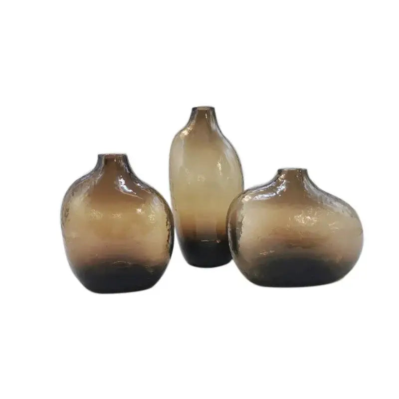 Set of three amber-tinted geometric zen glass vases with textured surfaces for single flower arrangement