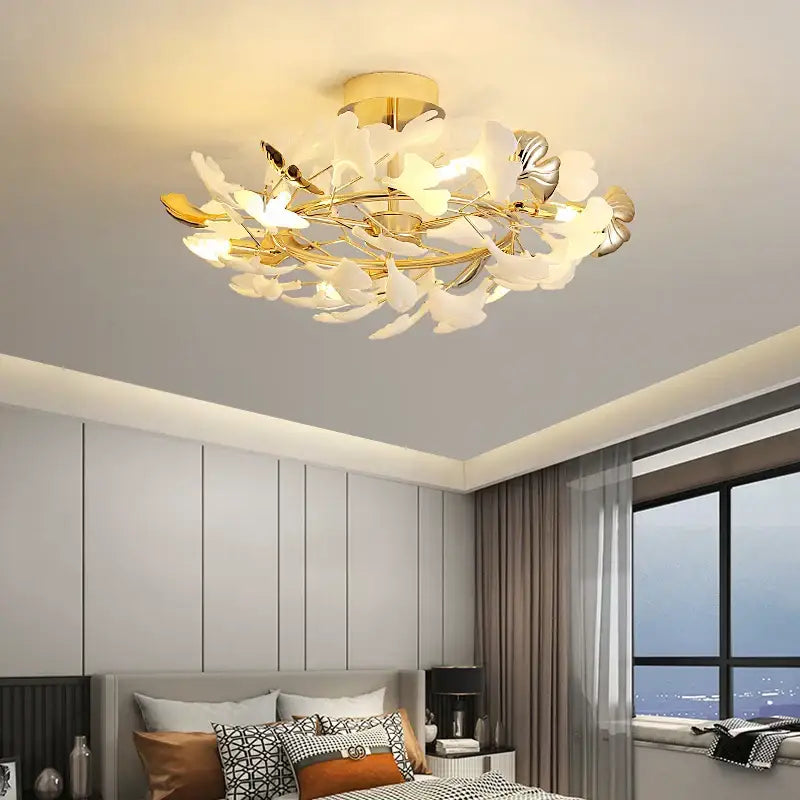 Gold-toned decorbites ginkgo leaf ceiling light with white and silver leaf accents for ginkgo leaf bedroom use