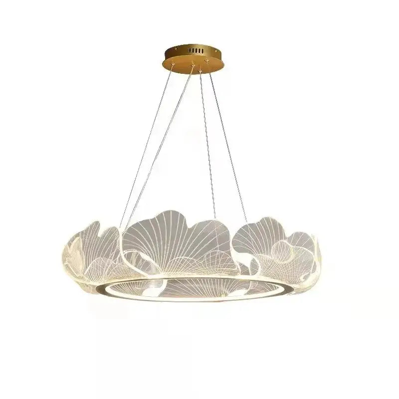 A modern decorbites ginkgo leaf pendant light with gold ceiling mount and translucent acrylic rings glowing softly
