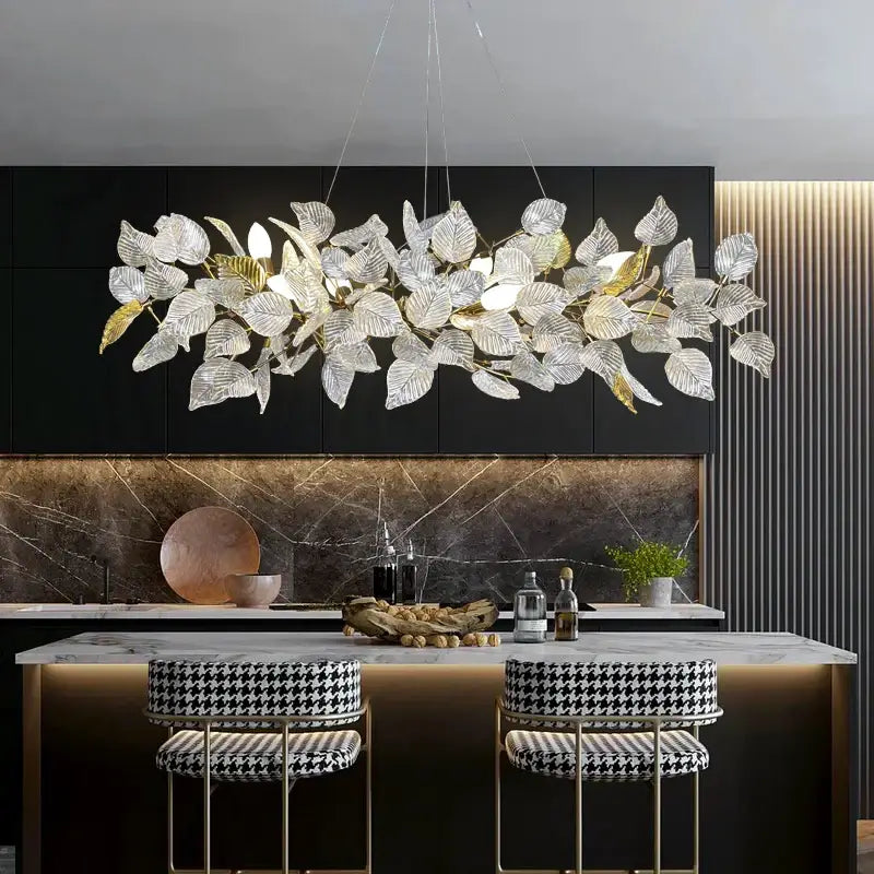 Elegant decorbites ginkgo leaf crystal chandelier with clear and gold-toned leaves above kitchen island