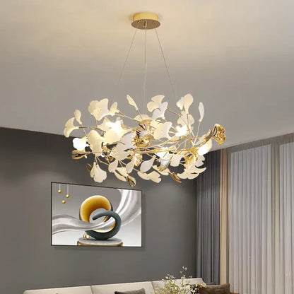 Gold-toned decorbites ginkgo leaf decor chandelier with delicate white glass leaves and modern branching design for living room