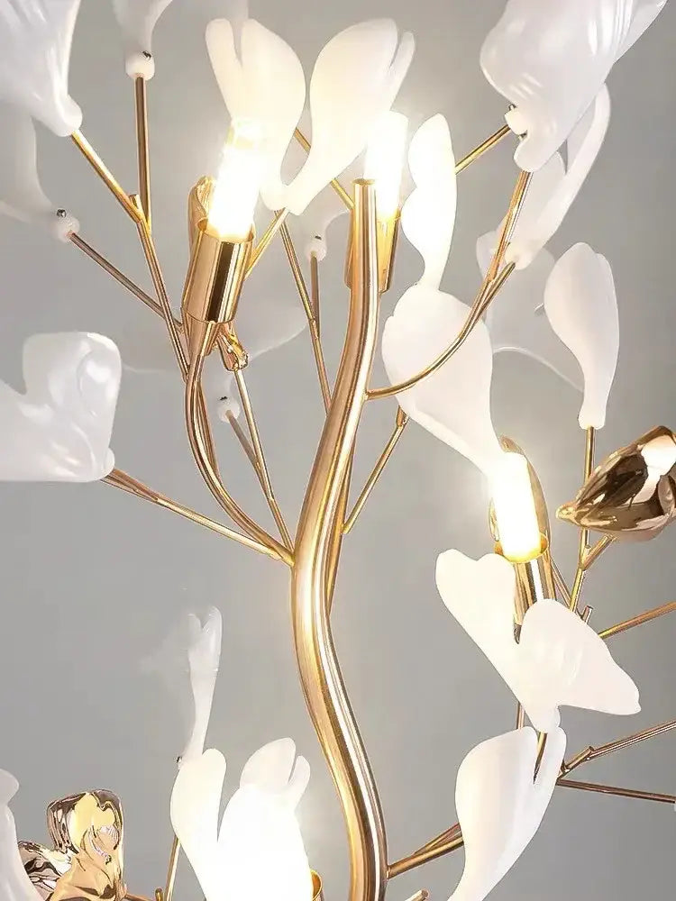 Decorbites ginkgo leaf floor lamp with a delicate white porcelain flower chandelier and gold-toned metal branches