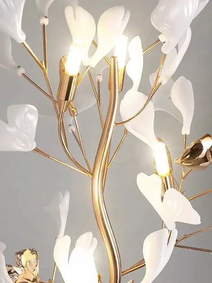 Decorbites ginkgo leaf floor lamp with a delicate white porcelain flower chandelier and gold-toned metal branches