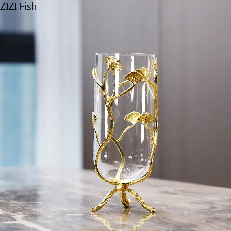 Elegant transparent glass vase by DecorBites featuring gold-toned ginkgo leaf metalwork and a three-legged base design