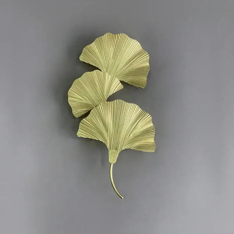 Gold-colored metallic ginkgo leaf wall lamp with three fan-shaped leaves by decorbites for hotel bedroom and corridor