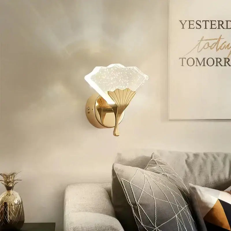Gold-finished decorbites ginkgo leaf wall lights with a translucent starry glass shade shaped like an open fan