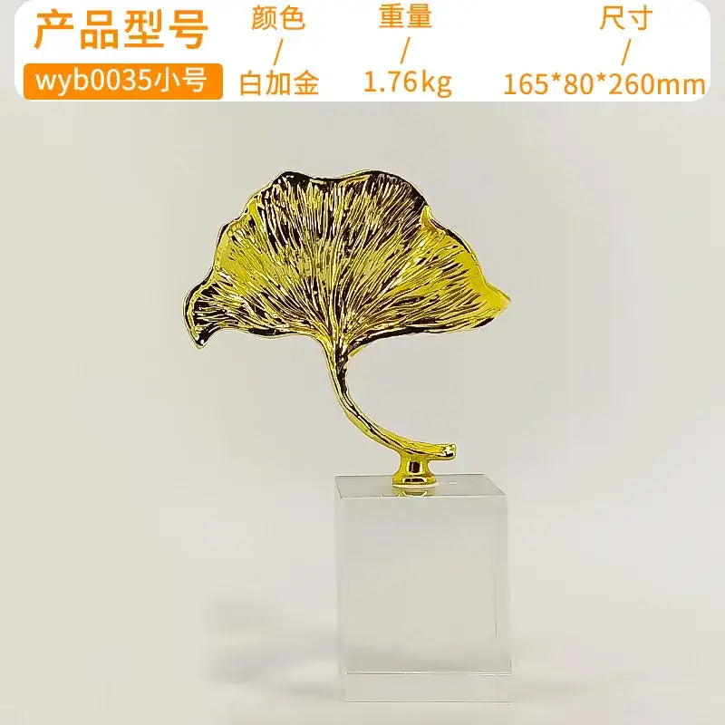 Decorbites ginkgo leaf metal sculpture in gold with intricate veins on clear acrylic base for home decor accent