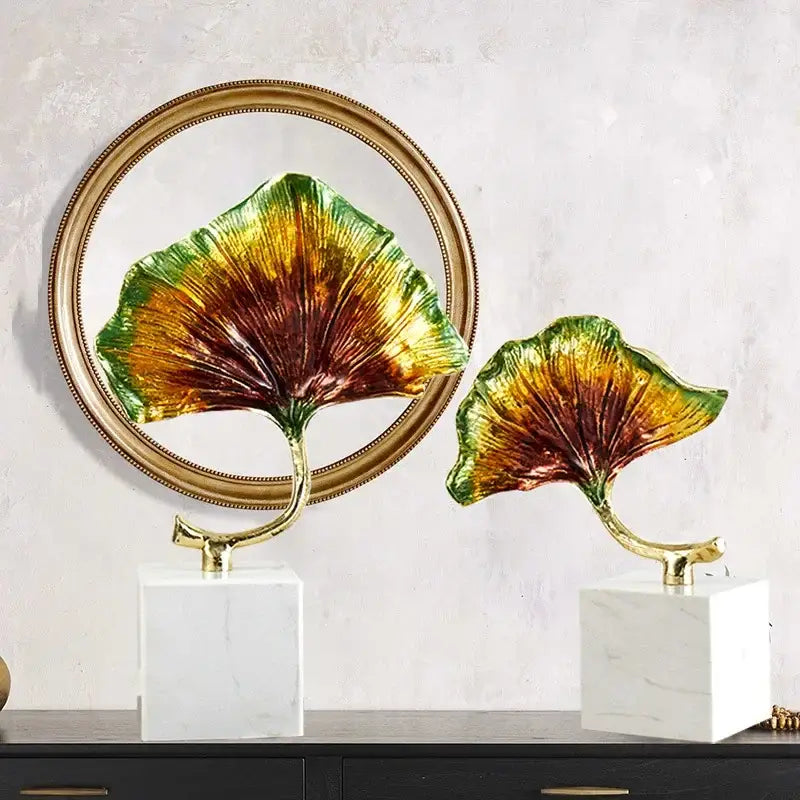 DecorBites ginkgo leaf metal sculpture with vibrant gold and green glossy leaves on metallic stems and white marble bases