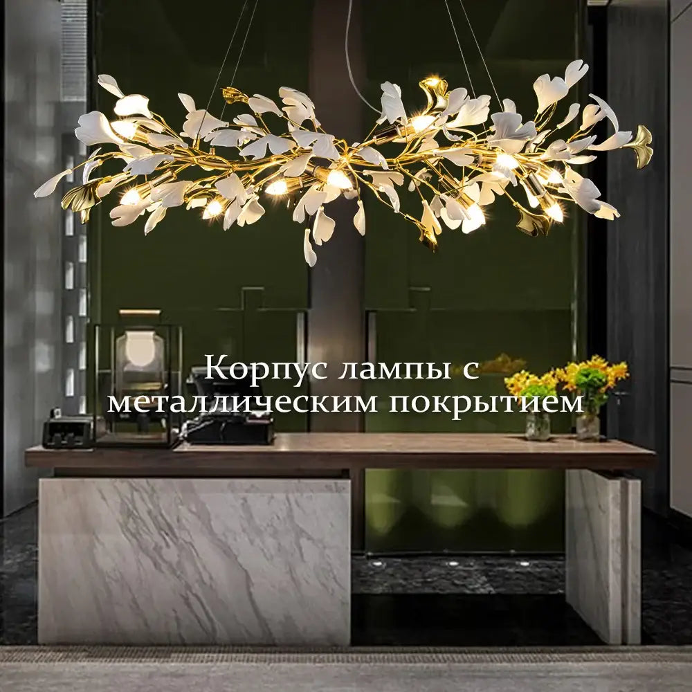 A modern decorbites ginkgo leaves chandelier with white and gold leaf fixtures and warm lights for luxury interiors