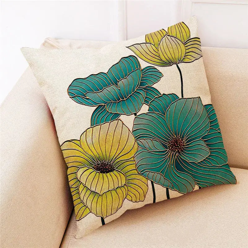 Beige linen cushion cover with embroidered teal and yellow lotus flowers and gold outlines from decorbites ginkgo leaves collection