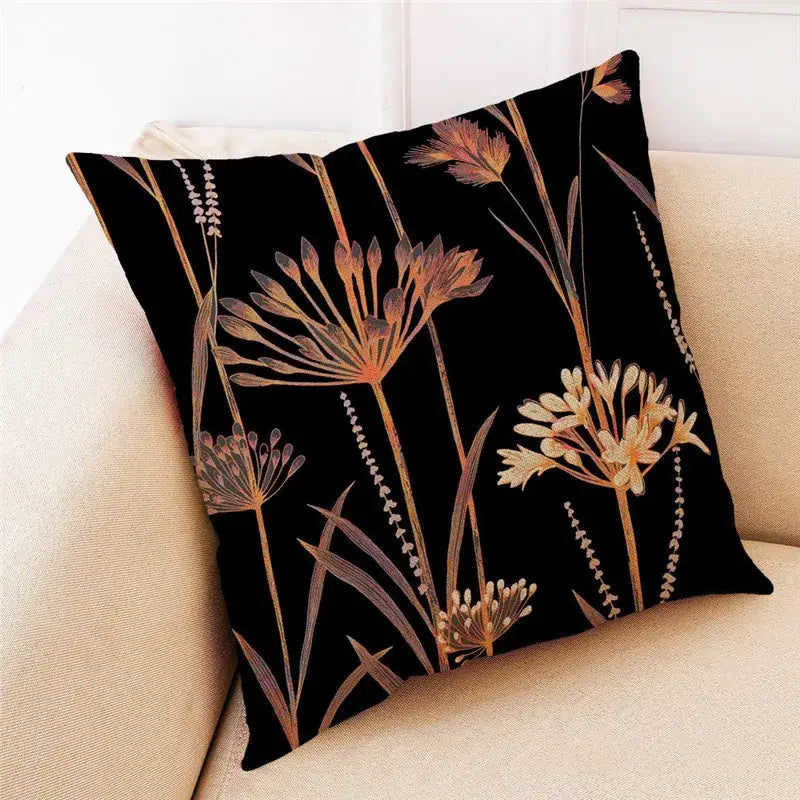 Black linen cushion cover featuring decorbites ginkgo leaves botanical print in warm gold and beige tones for living room decor
