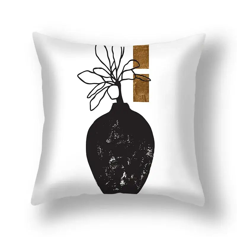White throw pillow with decorbites ginkgo leaves print featuring minimalist black vase silhouette and gold textured panels