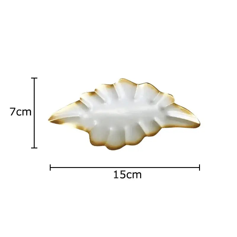 A white ceramic ginkgo leaves wall decor dish with gold-trimmed leaf design from decorbites ginkgo leaves collection