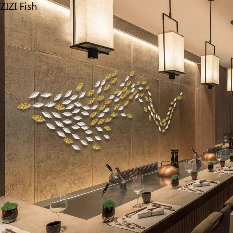 Decorbites™ gold and silver metallic fish-shaped wall hanging ornaments arranged in a flowing school pattern for living room decor