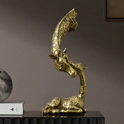 Golden resin giraffe head sculpture by decorbites with intricate textured pattern and elegant curved neck for interior decor