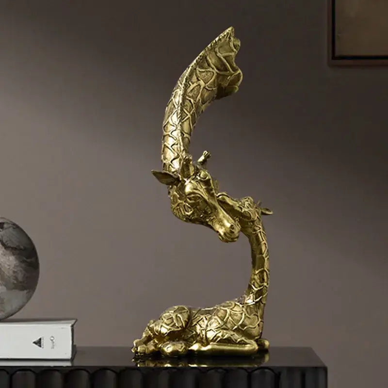 Golden resin giraffe head sculpture by decorbites with intricate textured pattern and elegant curved neck for interior decor