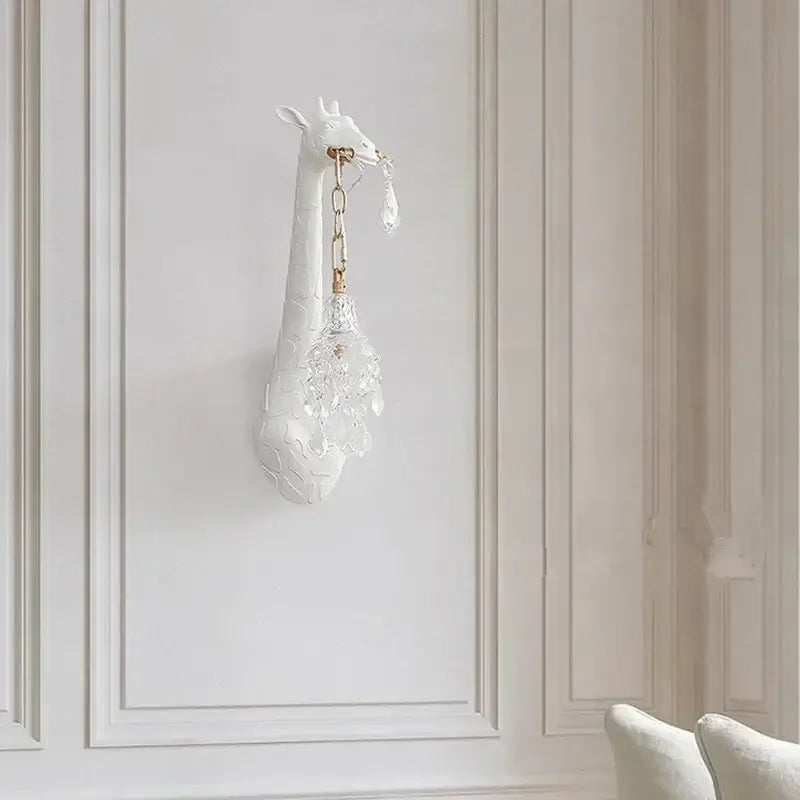 White ceramic resin wall lamp featuring a giraffe love wall design with crystal chandelier pendant for bedside decor